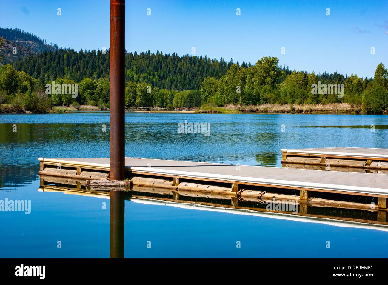 Pier Reflecting in a Calm Lake Stock Photo