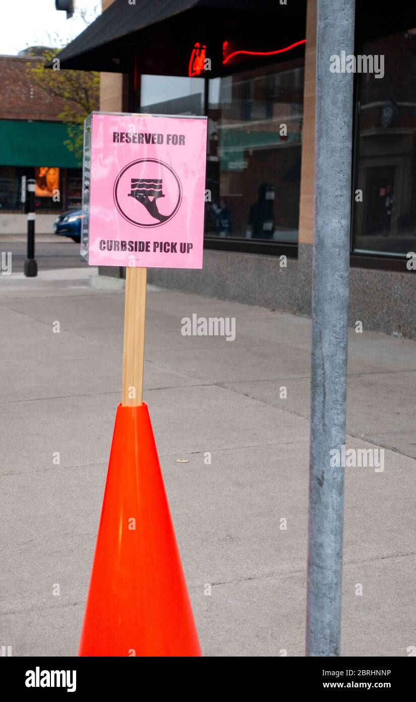 Parking sign for curbside food pick up at Cafe Latte because of the COVID-19 pandemic. St Paul Minnesota MN USA Stock Photo
