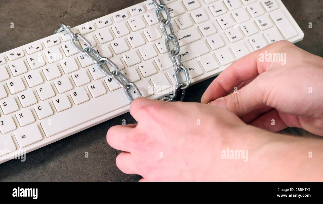 Hand close lock with chain on keaboard. Close up. Stock Photo