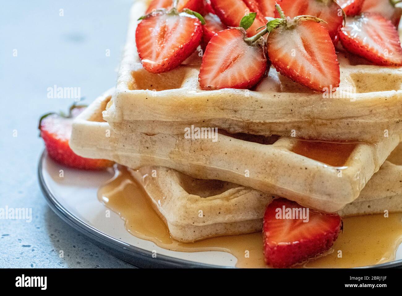 waffle breakfast with strawberry and honey maple syrup Stock Photo - Alamy
