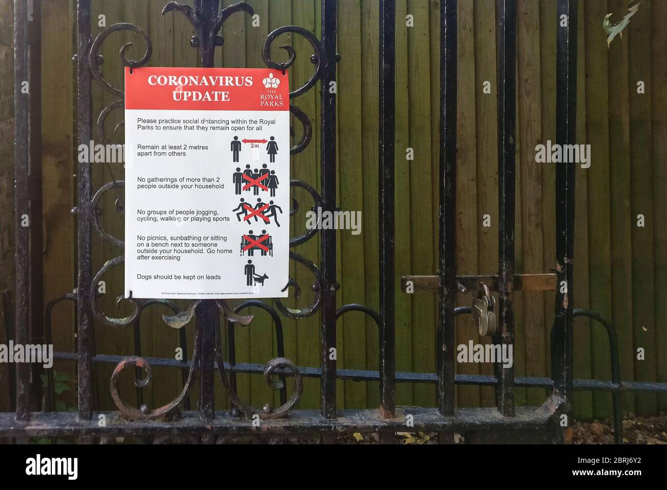 London, United Kingdom - April 27, 2020: Virus prevention advice safety sign on fence in Lewisham park due to coronavirus covid-19. Many public places Stock Photo