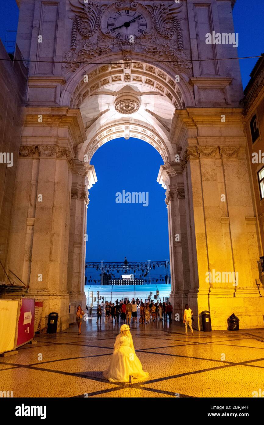 Europe, Portugal, Lisbon. A mime stands at the entrance of the arch overlooking the great square of Lisbon. Stock Photo
