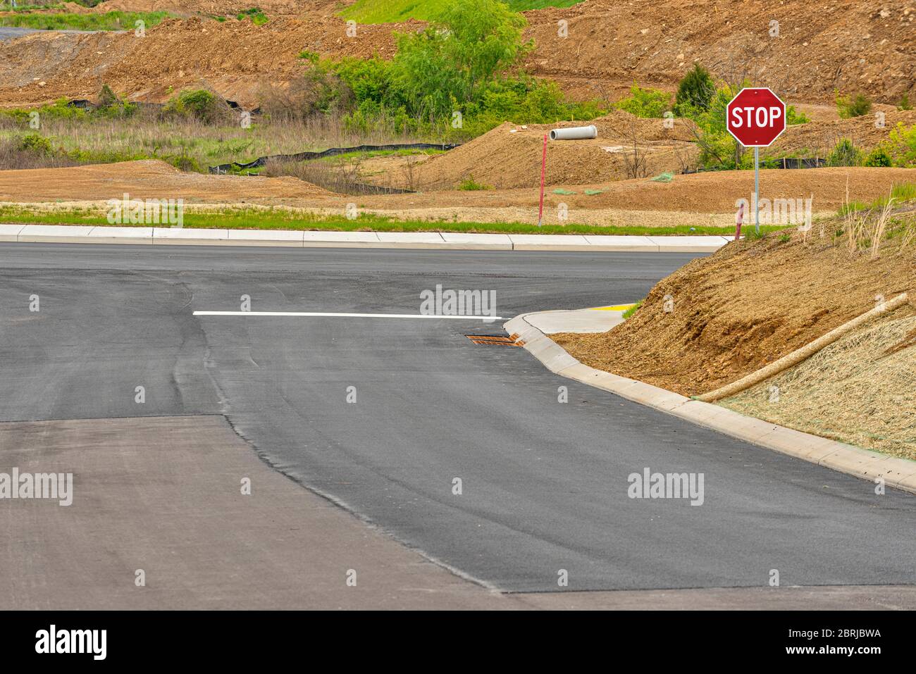 Horizontal shot of a street intersection in new residential construction. Stock Photo