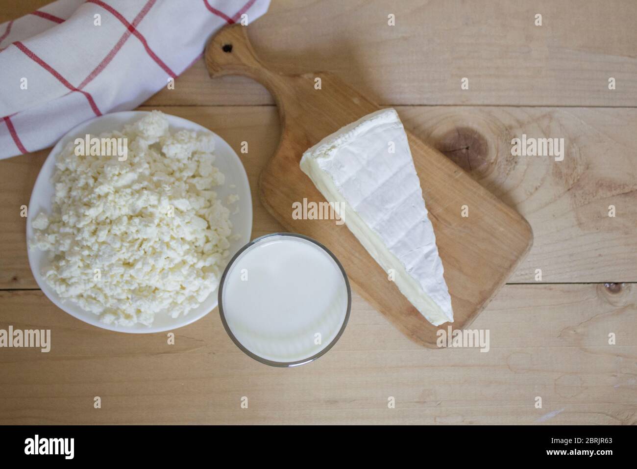 Tasty fresh milk is one of the main sources of nutrition. Mozzarella. Milk, cheese and apples. Rustic food. On a wooden background. View from above. c Stock Photo
