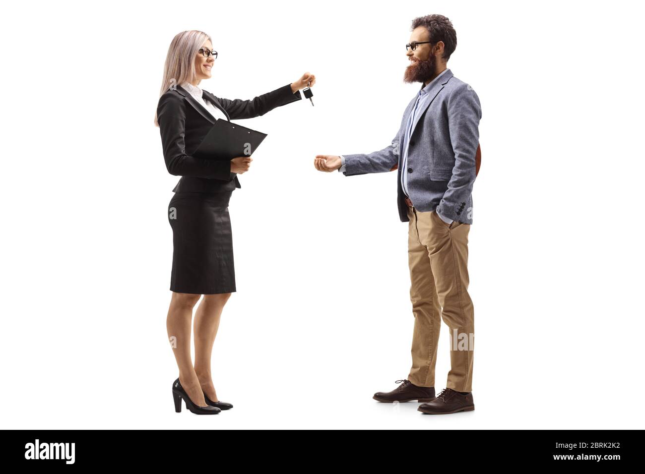 Full length profile shot of a businesswoman giving car keys to a bearded man isolated on white background Stock Photo