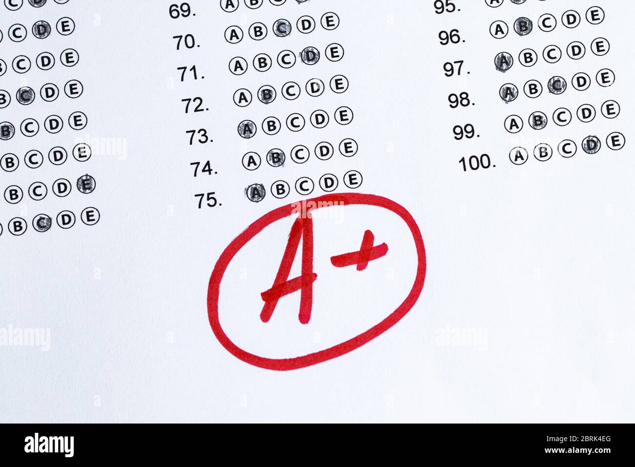 Final exam marked with A+ with red pencil Stock Photo - Alamy