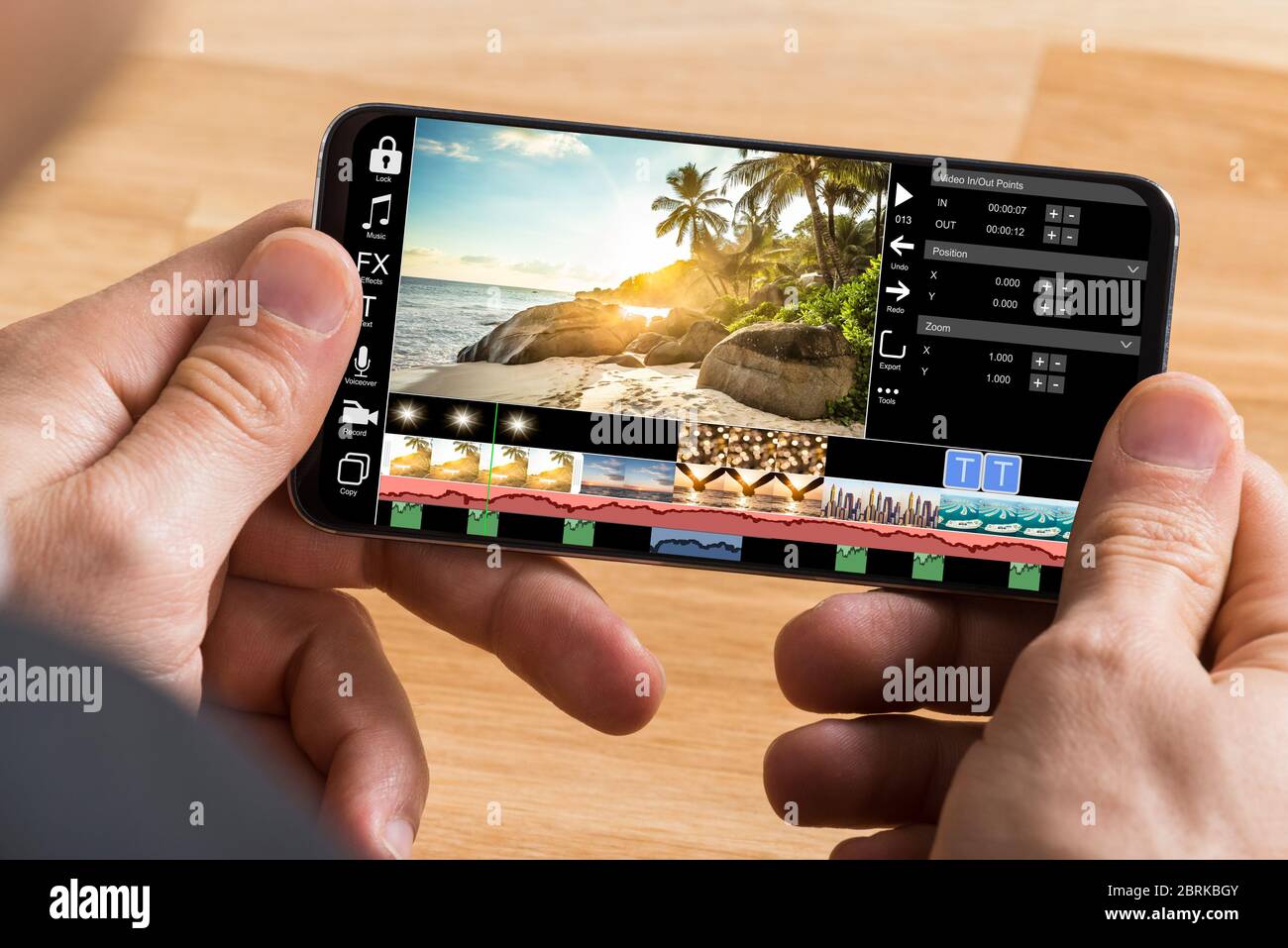 Editing Videos On Mobile Phone Using Video Editor App Stock Photo - Alamy