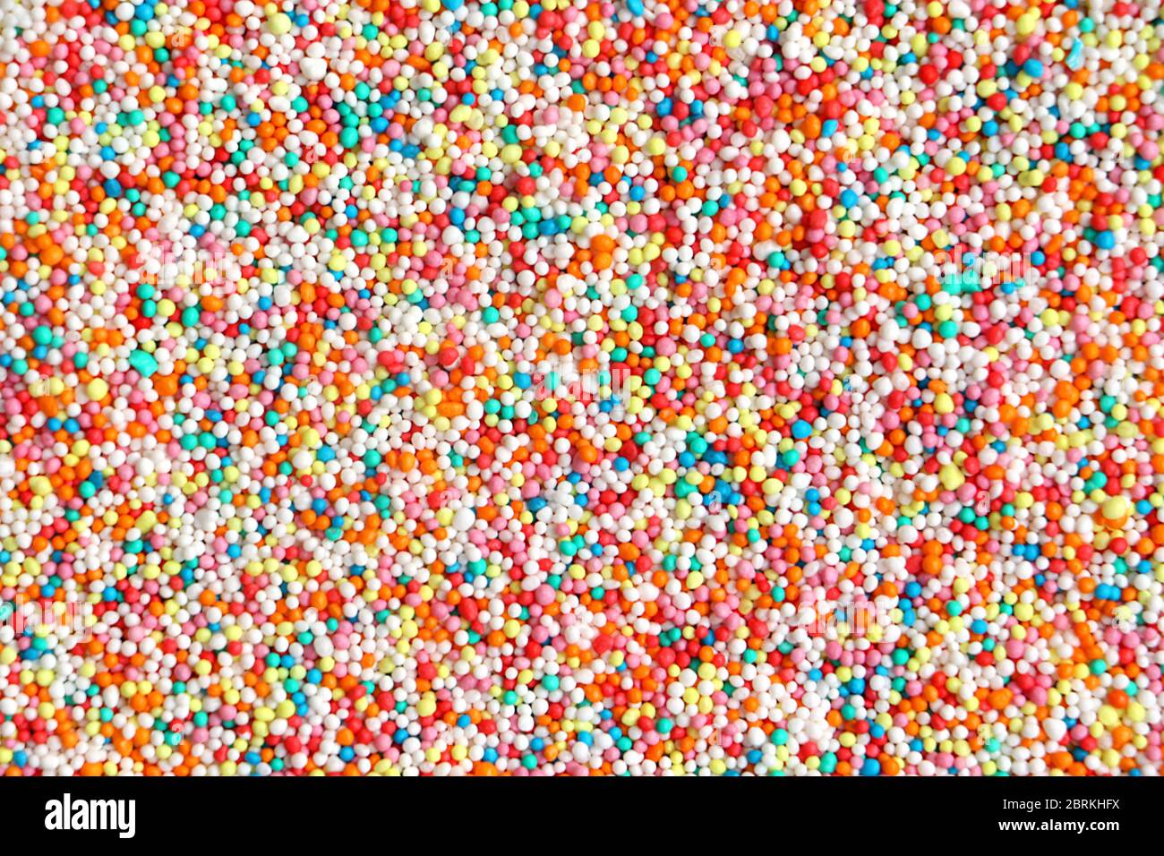 Colorful Hundreds and thousands confectionary isolated on a white background with space for text Stock Photo