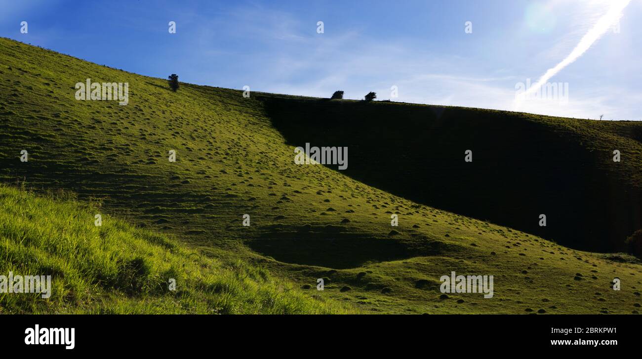 side of hill in silhouette Stock Photo