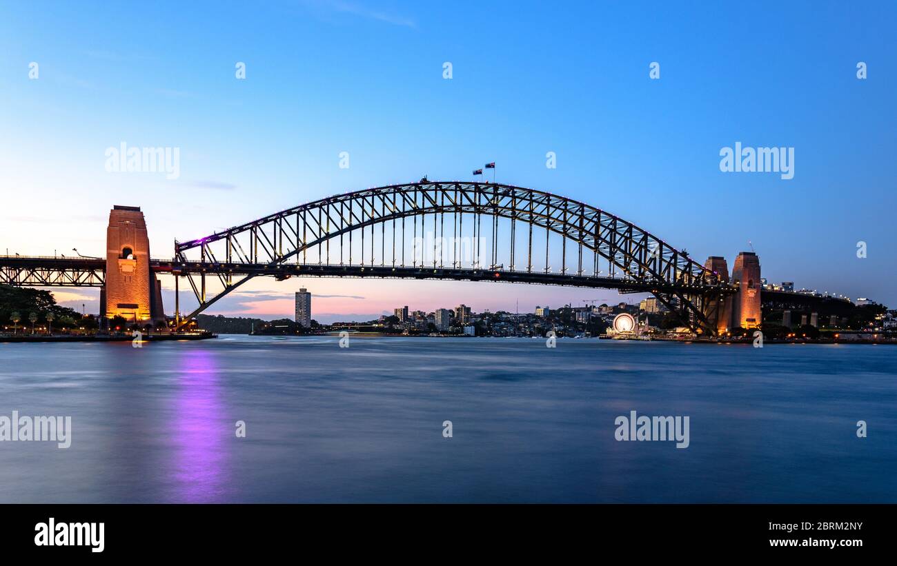 A long exposure of the Sydney Harbour Bridge with smooth water Stock Photo