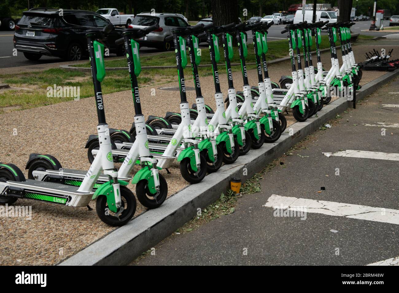 Washington, USA. 21st May, 2020. A general view of a line of Lime dock-less rental scooters in Washington, DC, on May 21, 2020 amid the Coronavirus pandemic. This week, the confirmed U.S. death toll from COVID-19 neared 100,000, while many states push to reopen their economies despite not meeting requirements recommended by public health experts for safe reopening. (Graeme Sloan/Sipa USA) Credit: Sipa USA/Alamy Live News Stock Photo