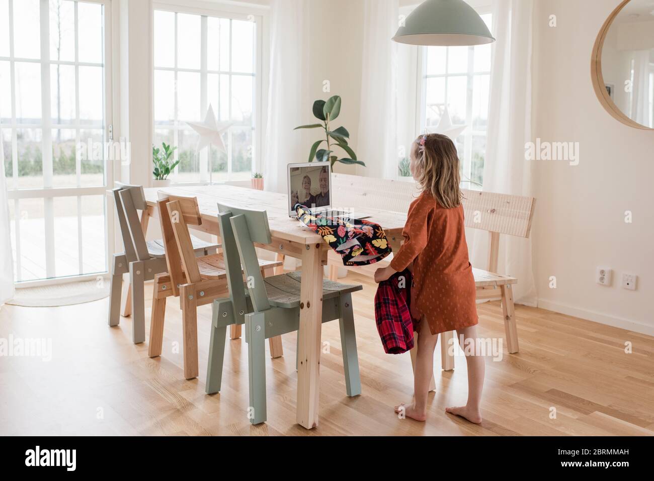 granddaughter showing her grandparents her new clothes on video call