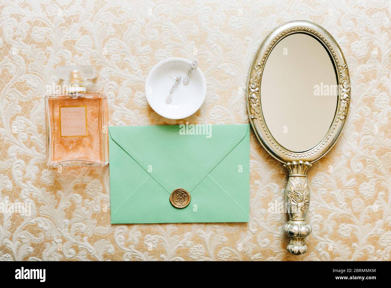 Bridal vintage mirror earings envelope chanel no 5 perfume Stock Photo