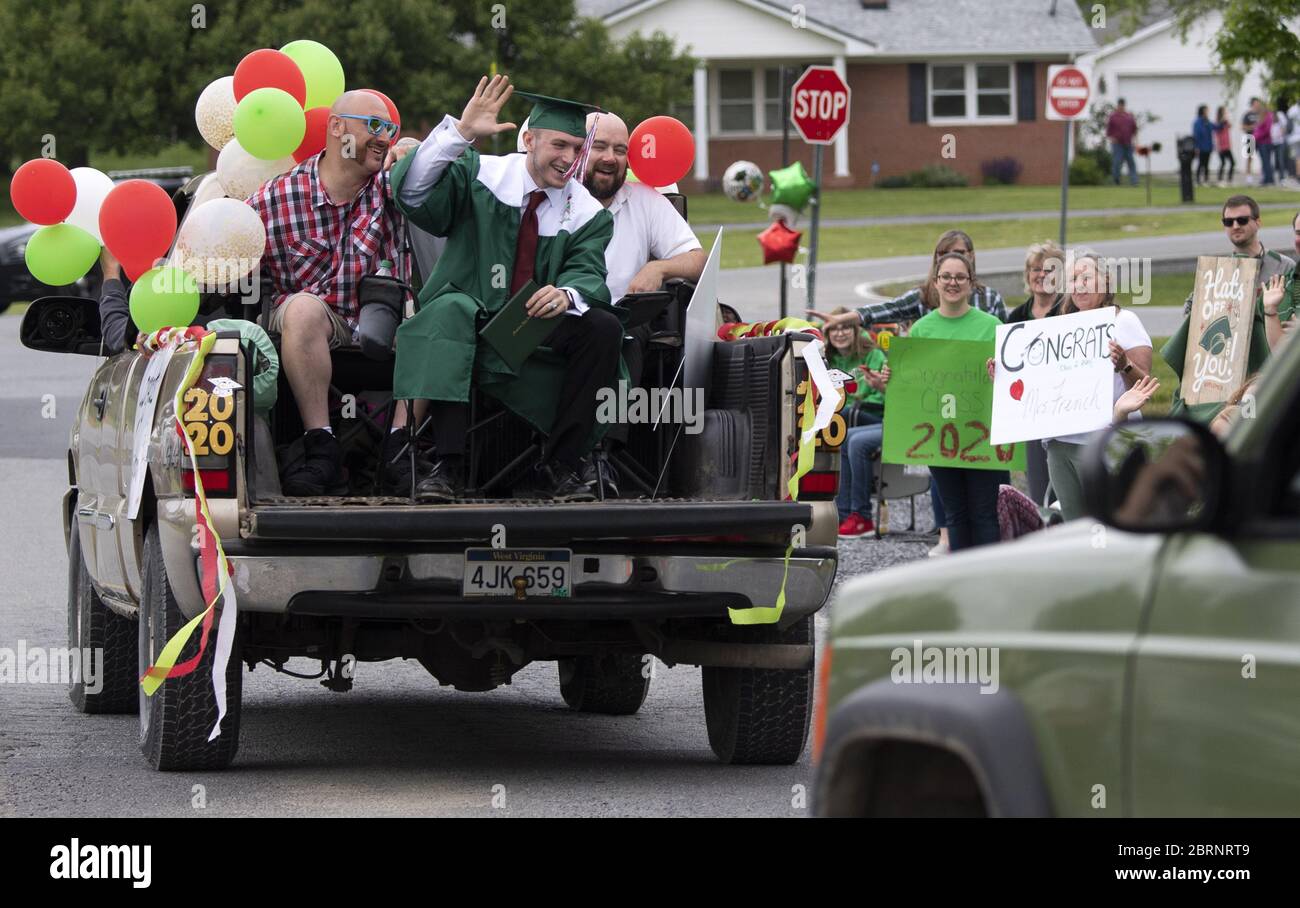 Washington, Untied States. 21st May, 2020. A class of 2020 graduate waves from his truck during his drive-through graduation ceremony at Musselman High School in Inwood, West Virginia on Thursday, May 21, 2020. Due to the COVID-19 pandemic the high school was forced to hold a social-distanced commencement ceremony. Photo by Kevin Dietsch/UPI Credit: UPI/Alamy Live News Stock Photo