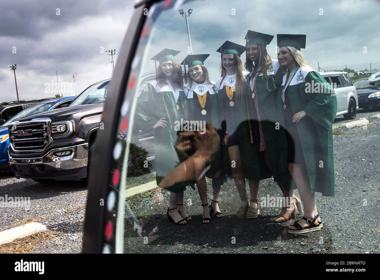 Washington, Untied States. 21st May, 2020. Member of the class of 2020 embrace as they wait for the start of their drive-through graduation ceremony at Musselman High School in Inwood, West Virginia on Thursday, May 21, 2020. Due to the COVID-19 pandemic the high school was forced to hold a social-distanced commencement ceremony. Photo by Kevin Dietsch/UPI Credit: UPI/Alamy Live News Stock Photo