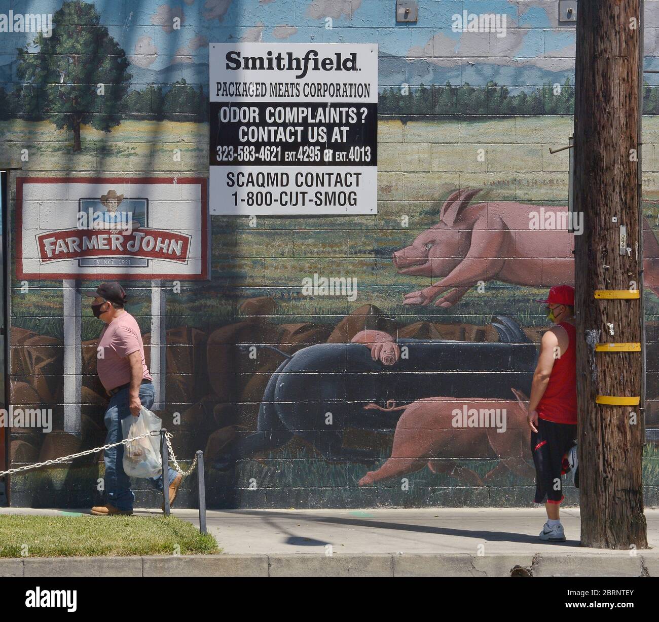 Los Angeles, United States. 21st May, 2020. Employees change shifts at a  Farmer John slaughterhouse in Vernon, California on Thursday, May 21, 2020.  A small group of activists were on hand to