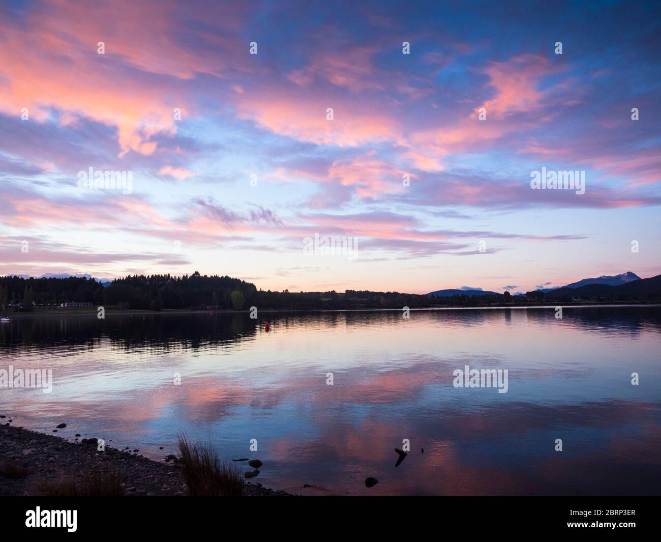 Pink sunrise over Lake Te Anau, Fiordland, New Zealand Stock Photo