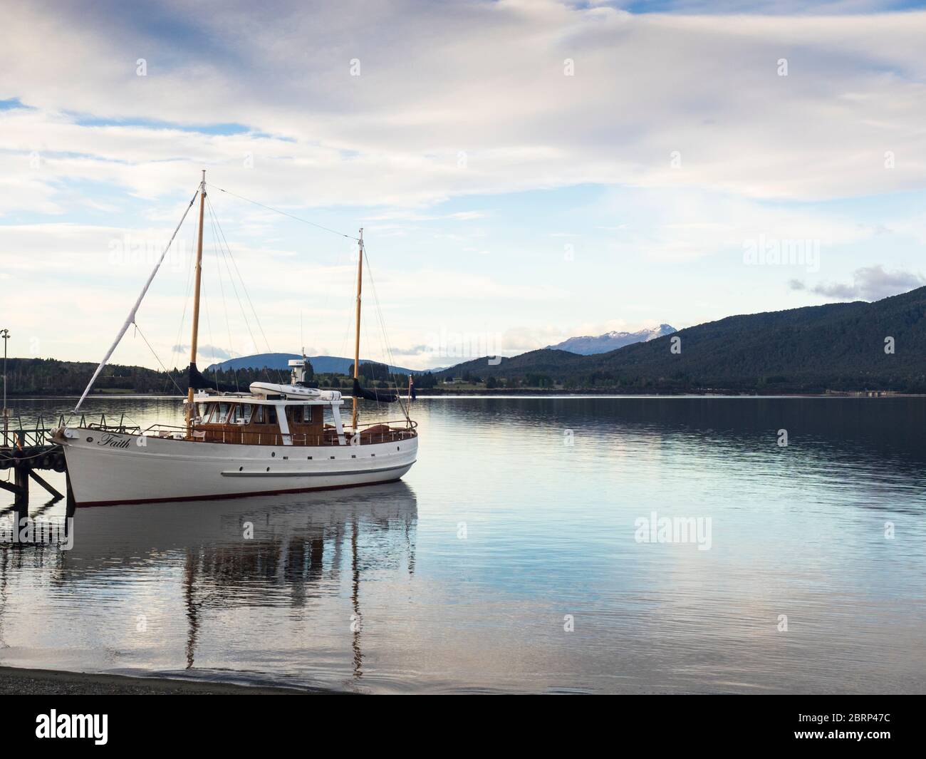 Motor sailer 'Faith' moored on Lake Te Anau, Fiordland, South Island, New Zealand Stock Photo