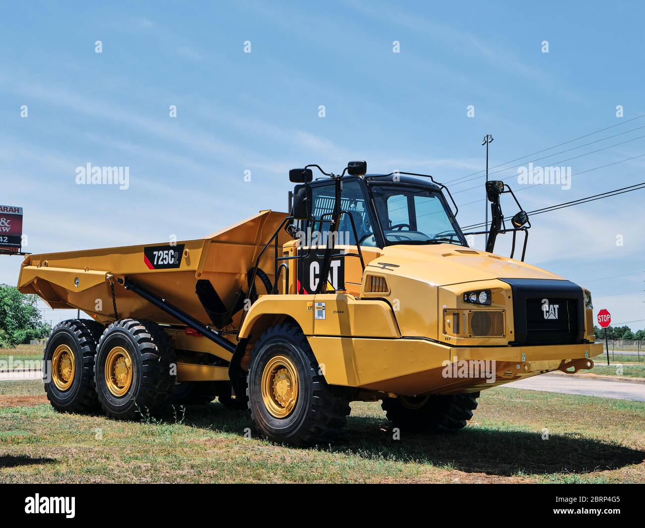 New CAT 725C2 articulated earth mover or hauler on display in front of a Caterpillar heavy equipment sales lot in Montgomery Alabama, USA. Stock Photo