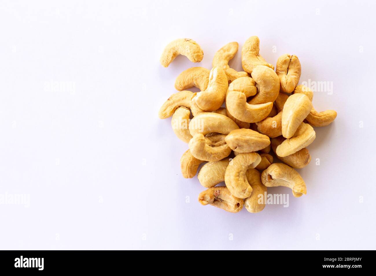 Many Roasted salted cashew nuts  isolated on a white background Stock Photo