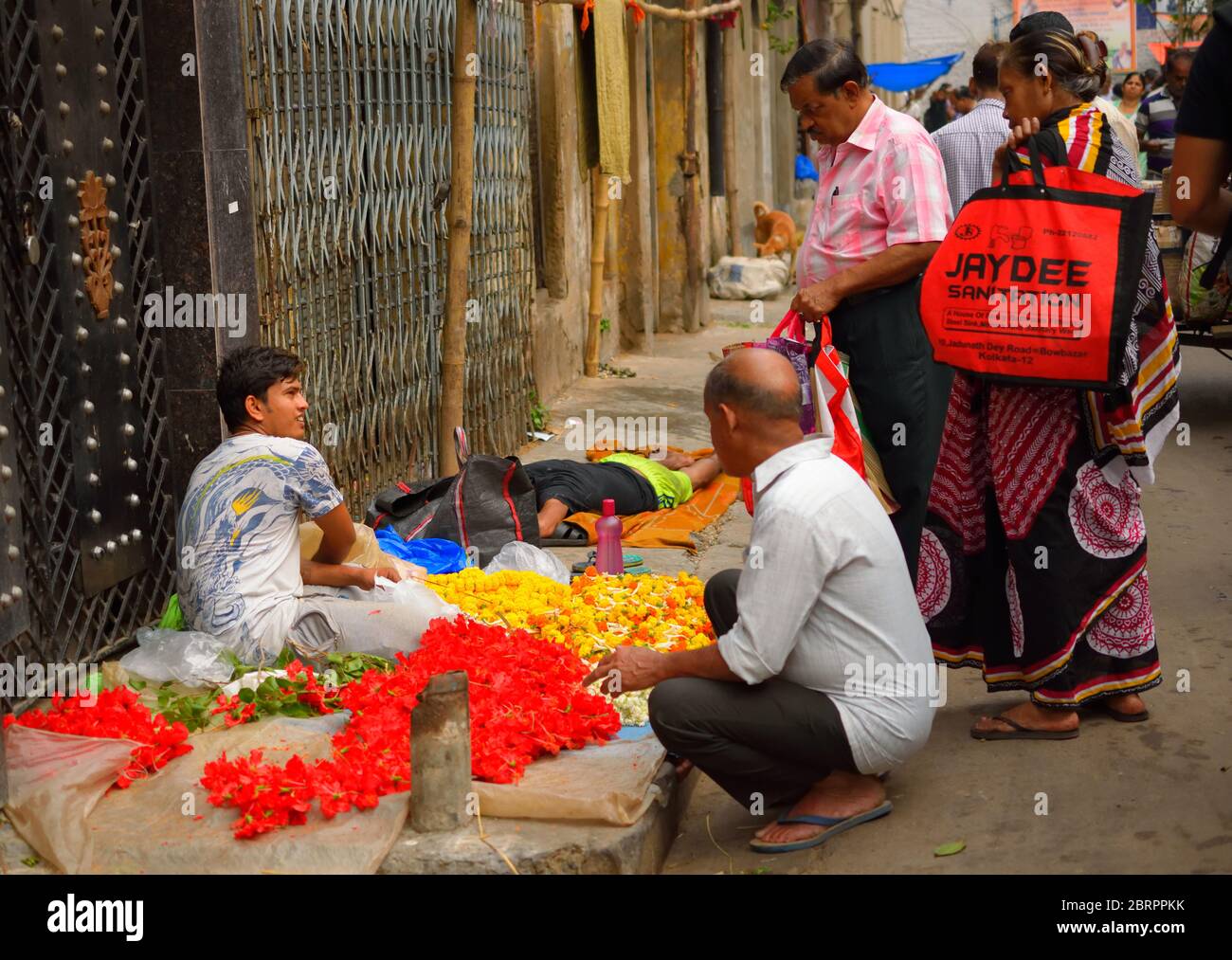 People buying flowers from a street vendor. Stock Photo