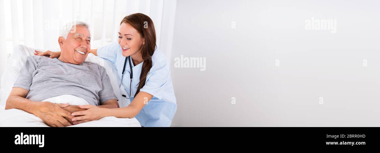 Nurse And Happy Patient. Home Care Or Hospital Stock Photo