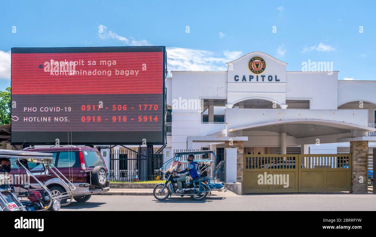 Calapan City, Philippines - Mar 16, 2020. A provincial government sign with hotline numbers warns that Covid-19 can cling to contaminated objects. Stock Photo