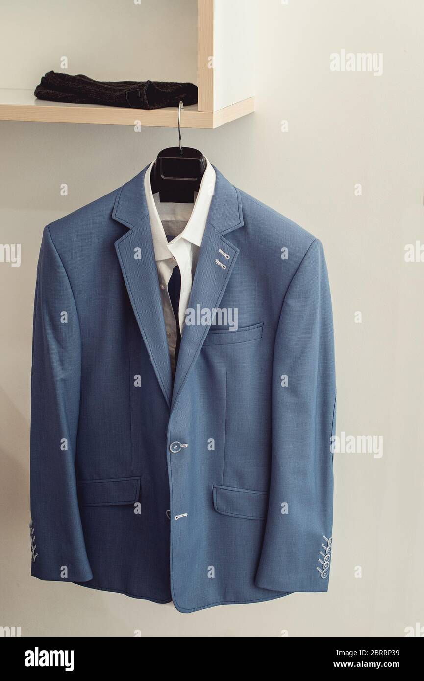 blue suit jacket with a white shirt on the rack Stock Photo Alamy