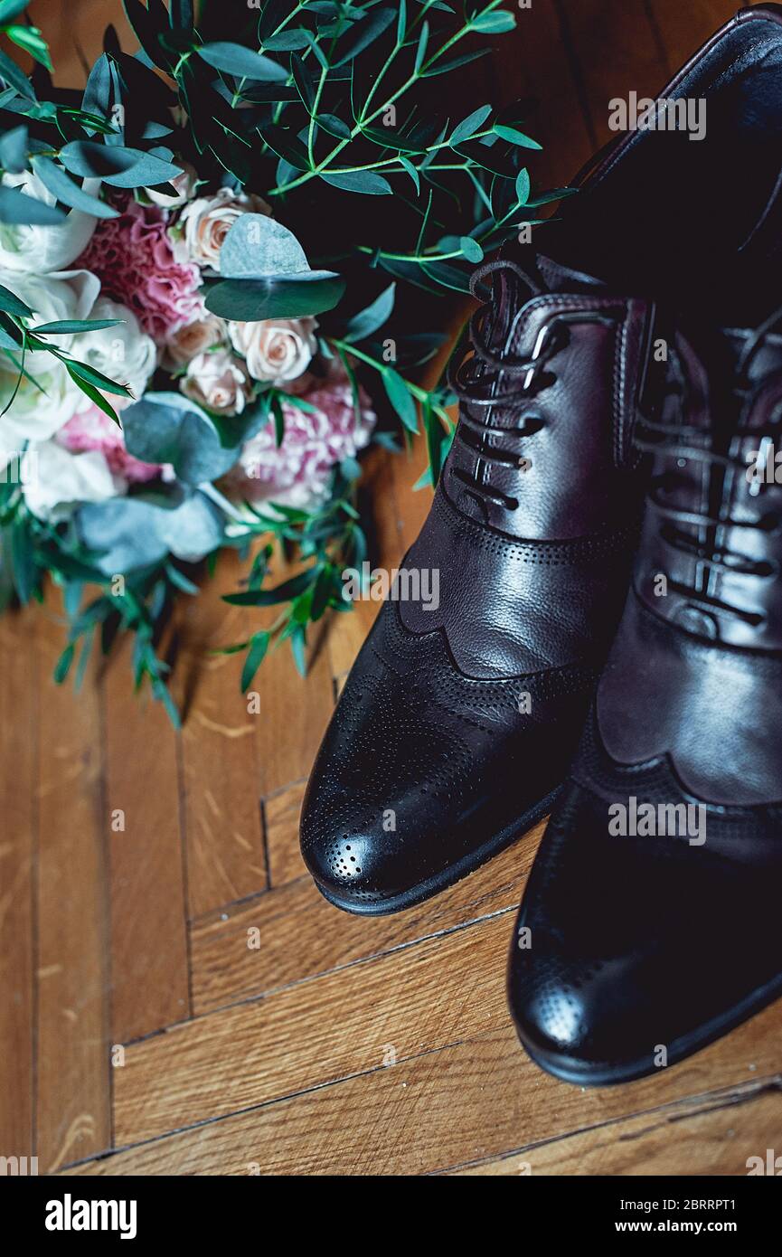 https://c8.alamy.com/comp/2BRRPT1/close-up-of-modern-man-accessories-black-bowtie-leather-shoes-belt-and-wedding-bouquet-on-wood-rustic-background-set-for-formal-style-of-wearing-2BRRPT1.jpg