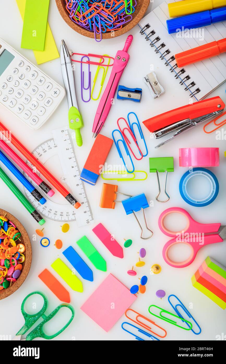 School office supplies flat lay on white background, top view. Business  stationery, student desk concept, vertical Stock Photo - Alamy