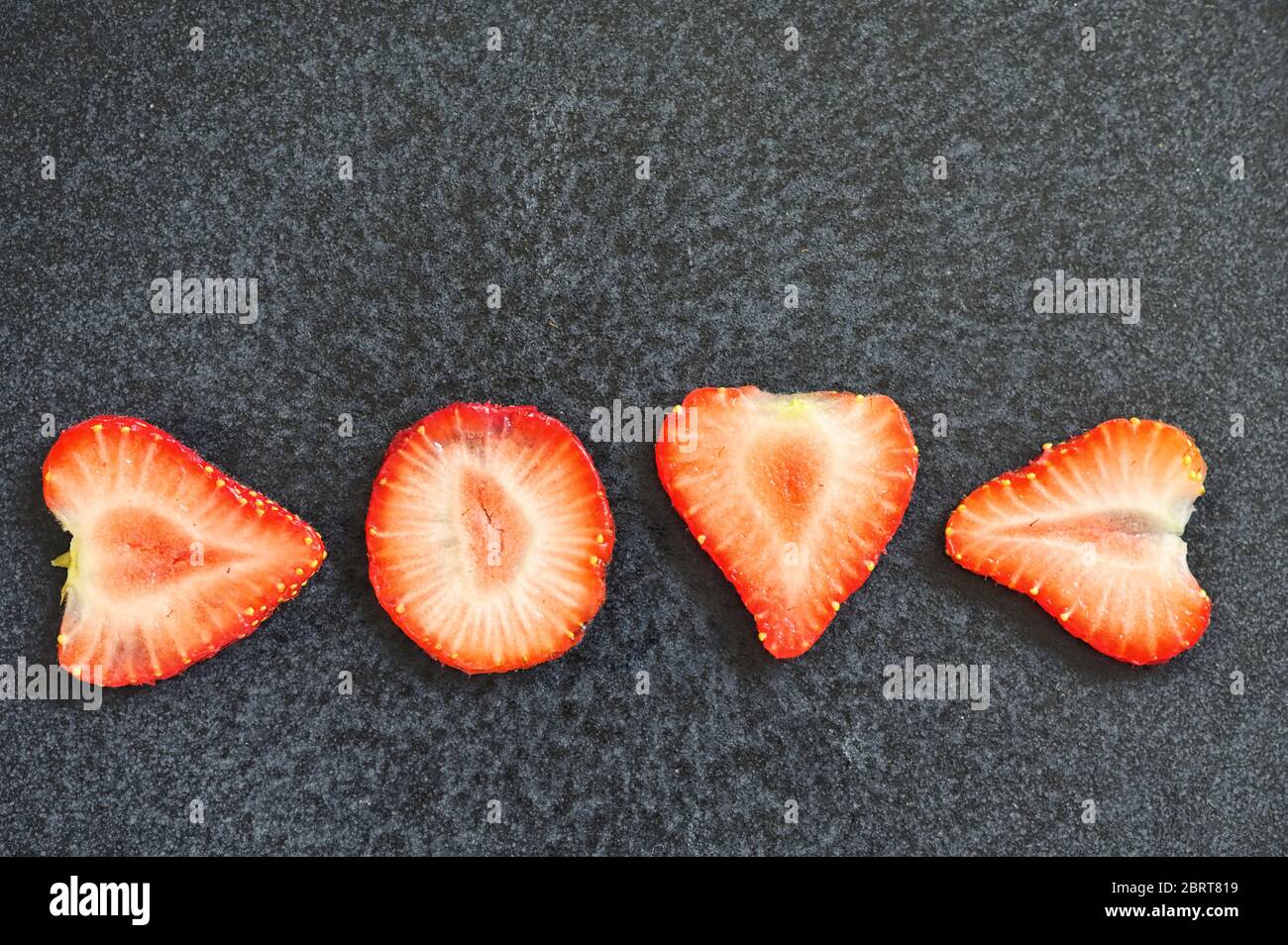 Love Letters Strawberry Slices Isolated On Black Background Stock Photo
