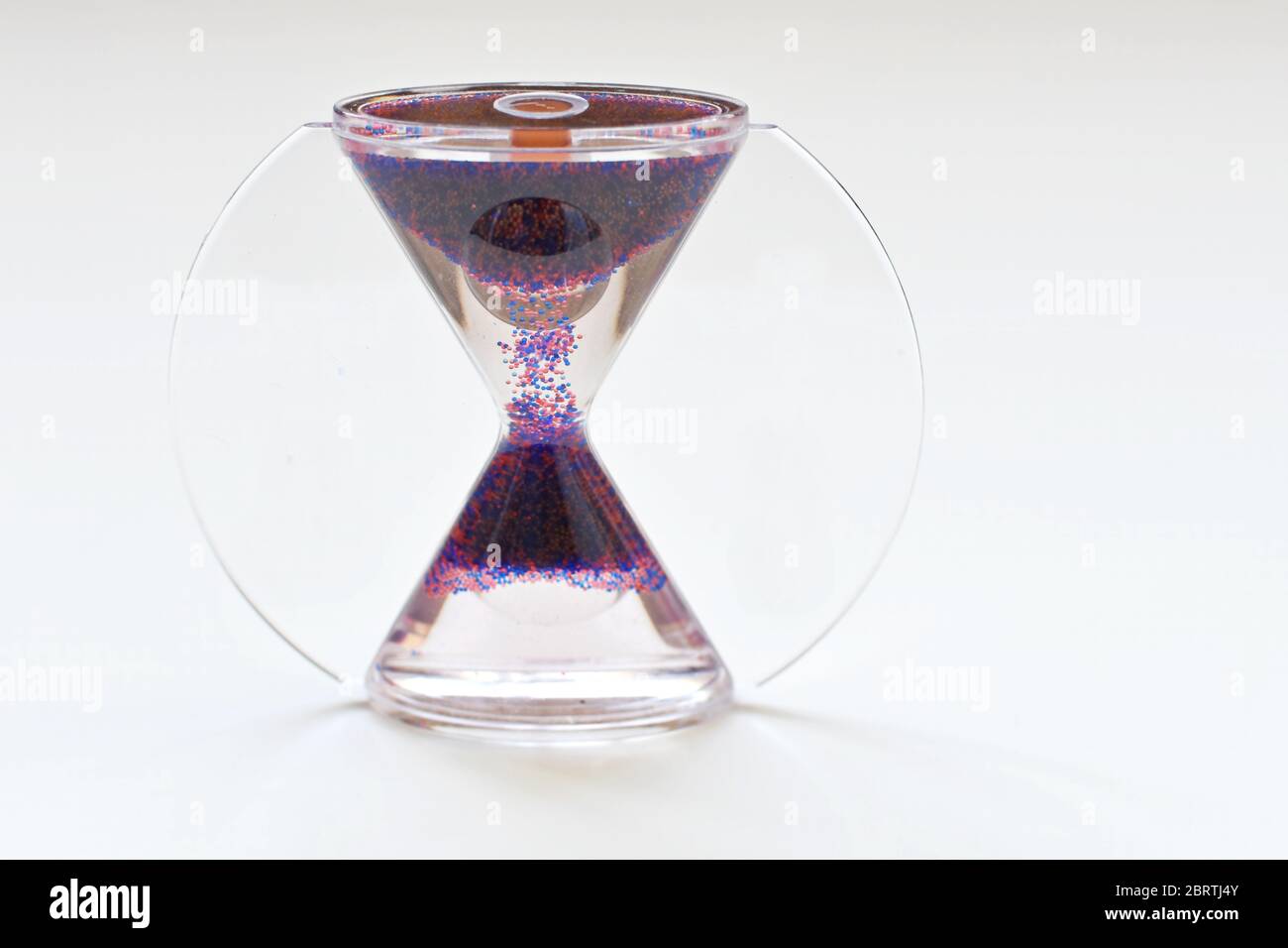 Front view of an hourglass (clepsydra, sand glass) on white background. Stock Photo