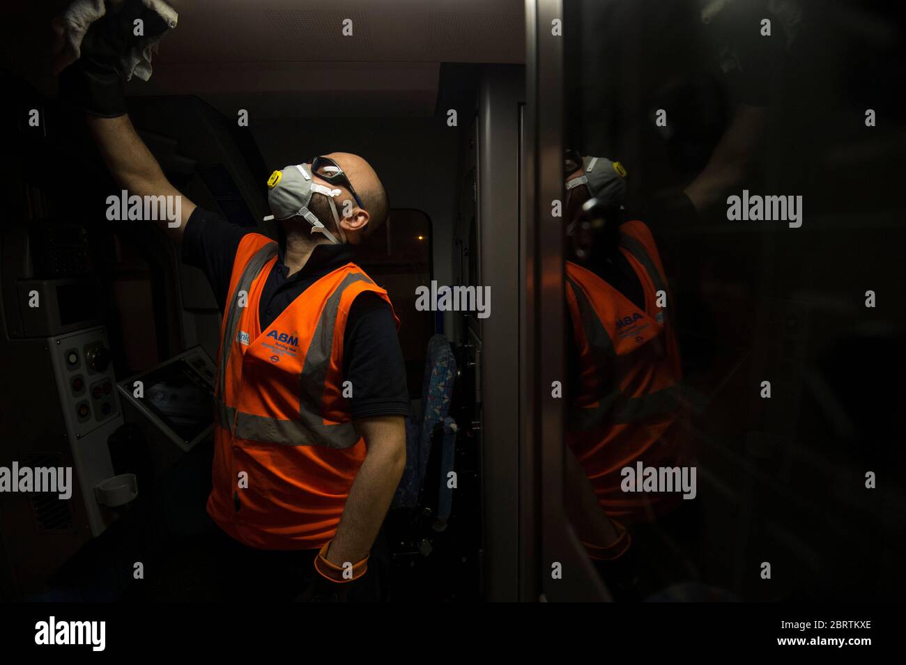 A TfL worker deep cleans the drivers cabin area of a Victoria Line tube