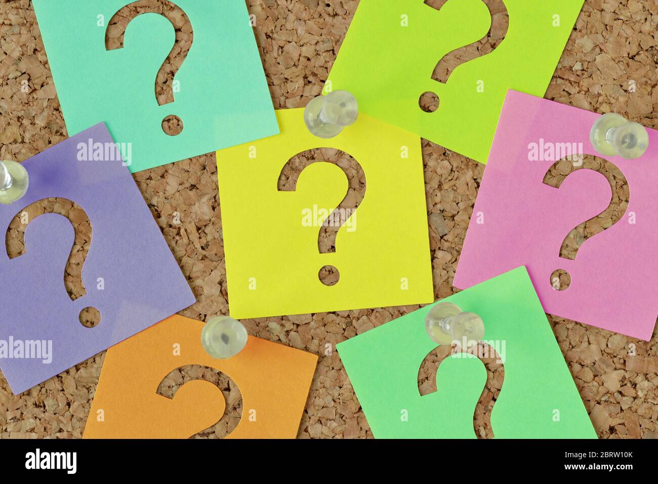 Post it notes with question mark on notice board Concept of faq and