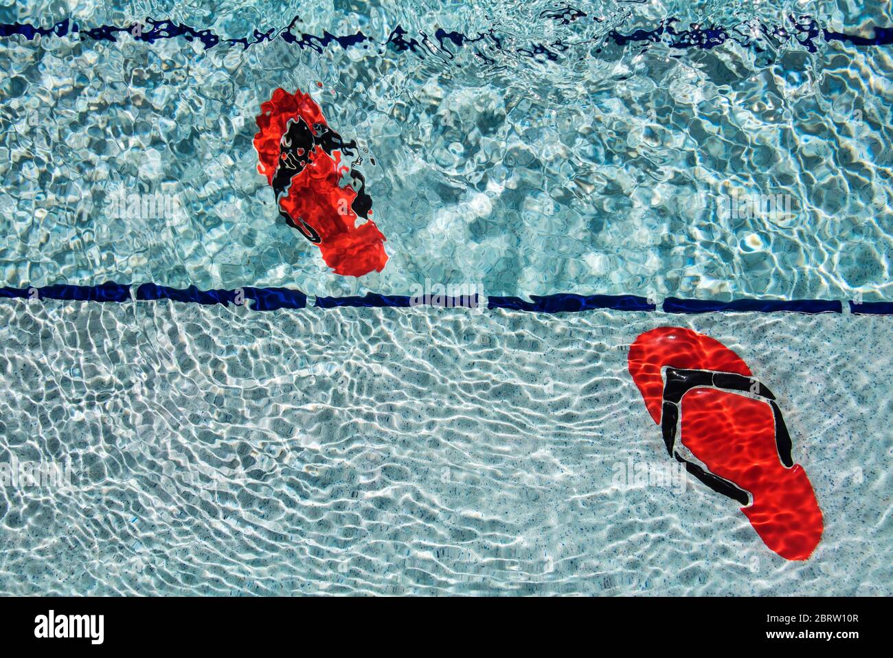 Flip flop design tiles at bottom of swimming pool. Stock Photo