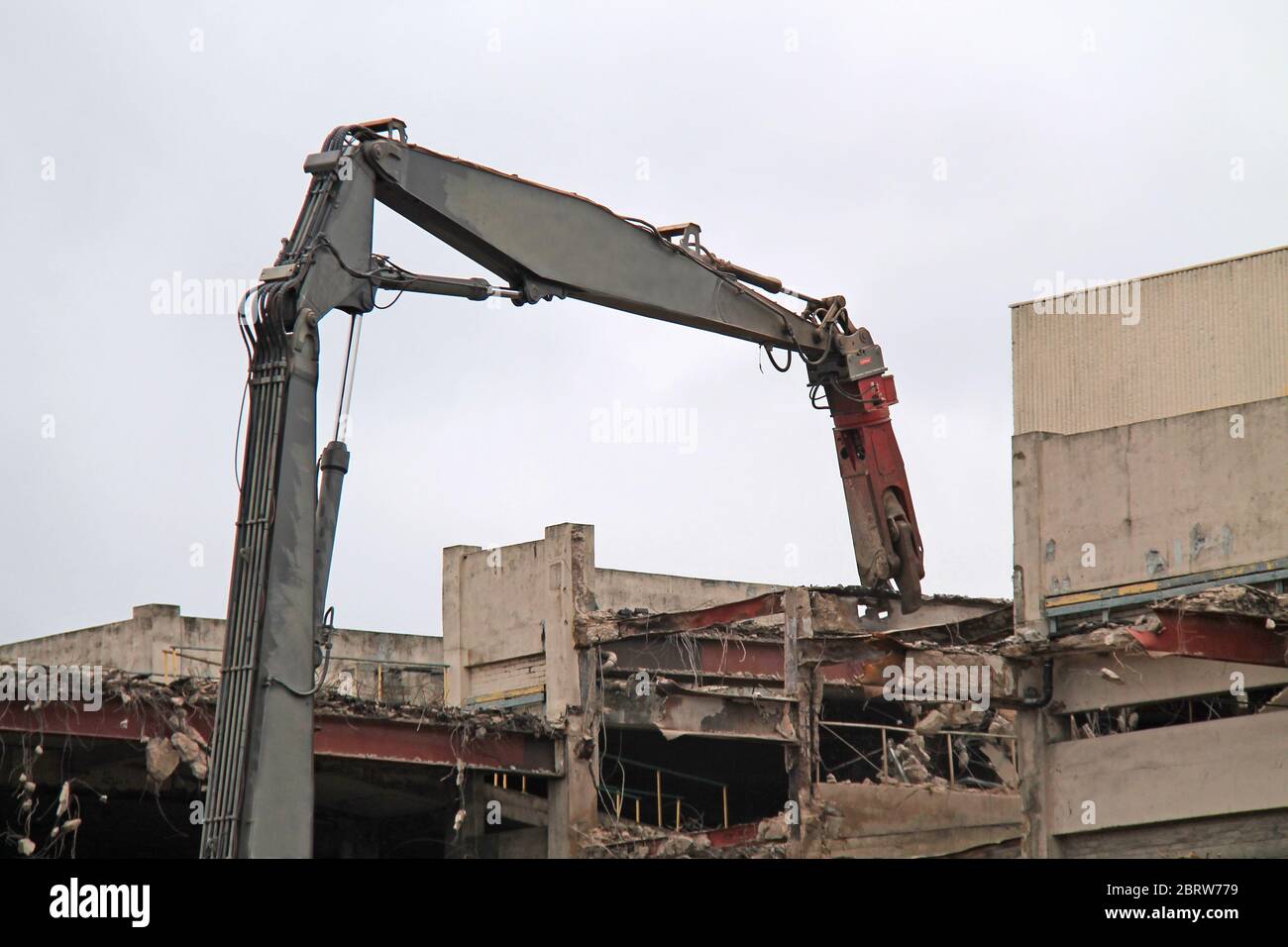 A Pulveriser Machine Pulling Out a Building Steel Girder. Stock Photo
