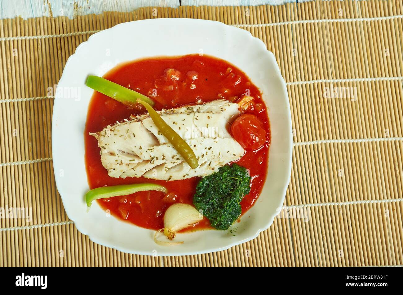 Herb  garlic baked cod with romesco sauce and  spinach Stock Photo