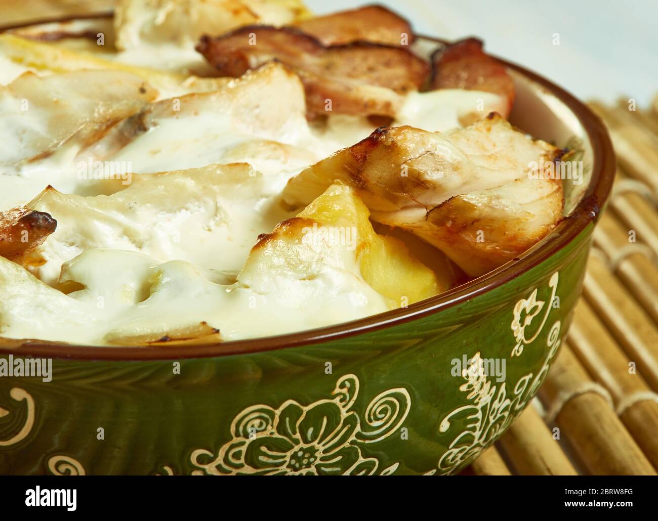 Smoked haddock savoy cabbage,bacon and creamy potato gratin Stock Photo