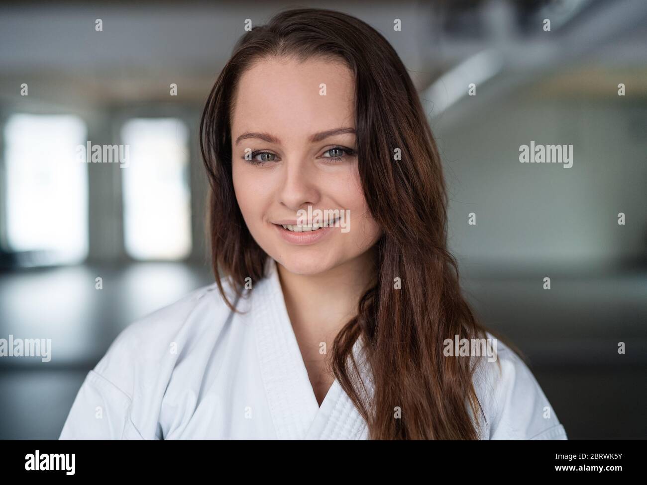 A portrait of young karate woman standing indoors in gym. Stock Photo
