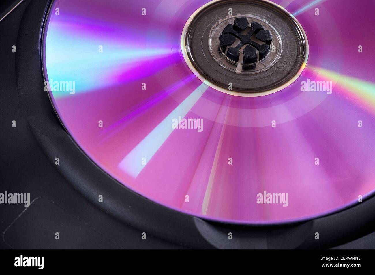 Back side of a dvd disс with some dust. Low key. Close up. Stock Photo