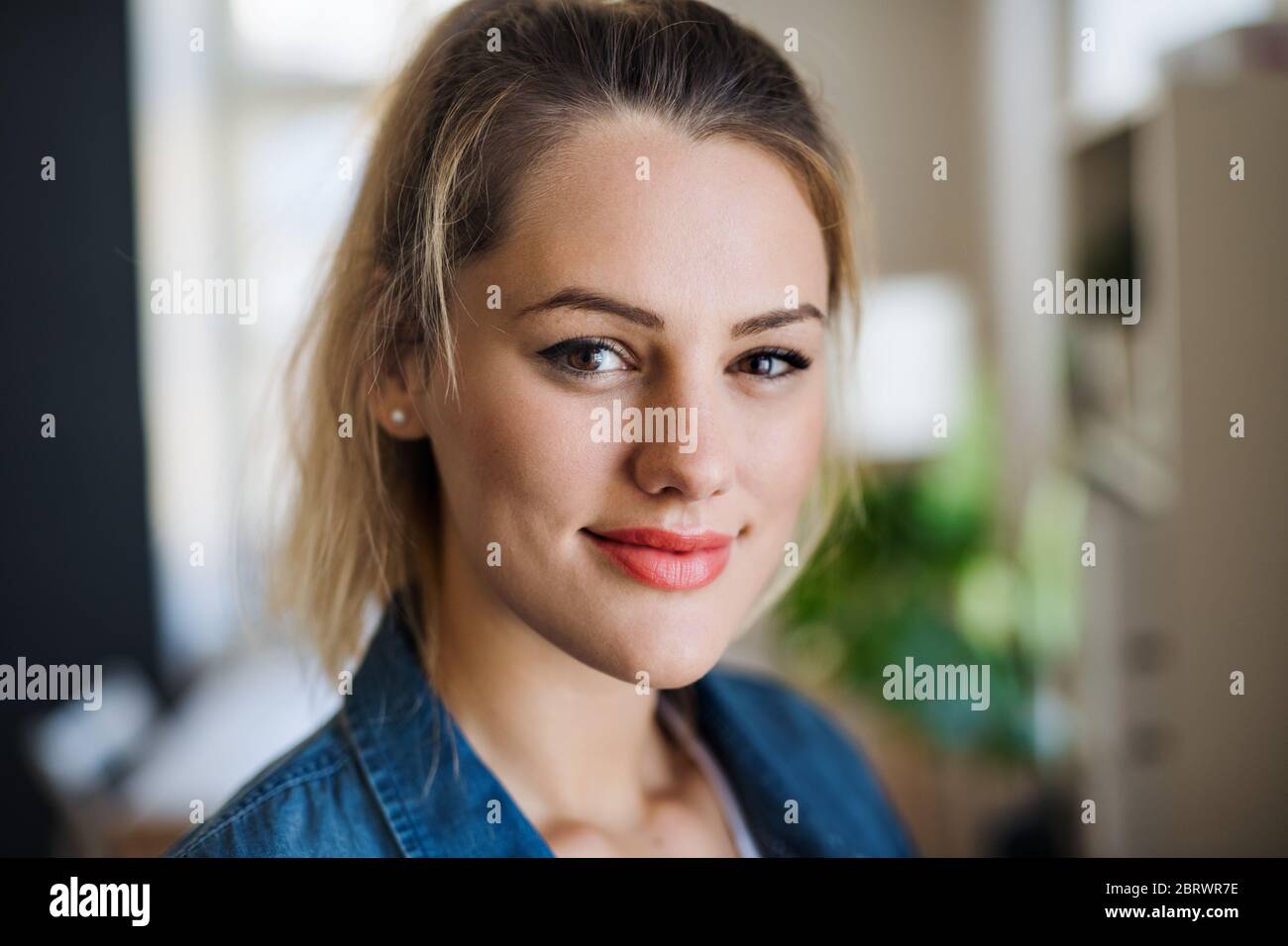 Close-up portrait of happy young woman indoors at home. Stock Photo
