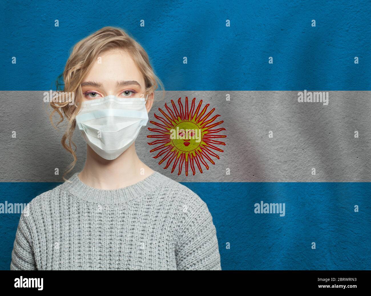 Young woman wearing a face mask with national flag Argentina. Flu ...
