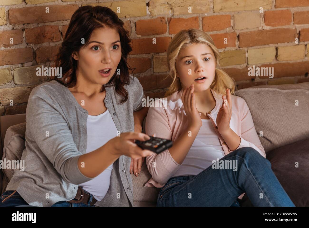 Selective focus of excited mother and daughter watching movie at home Stock  Photo - Alamy