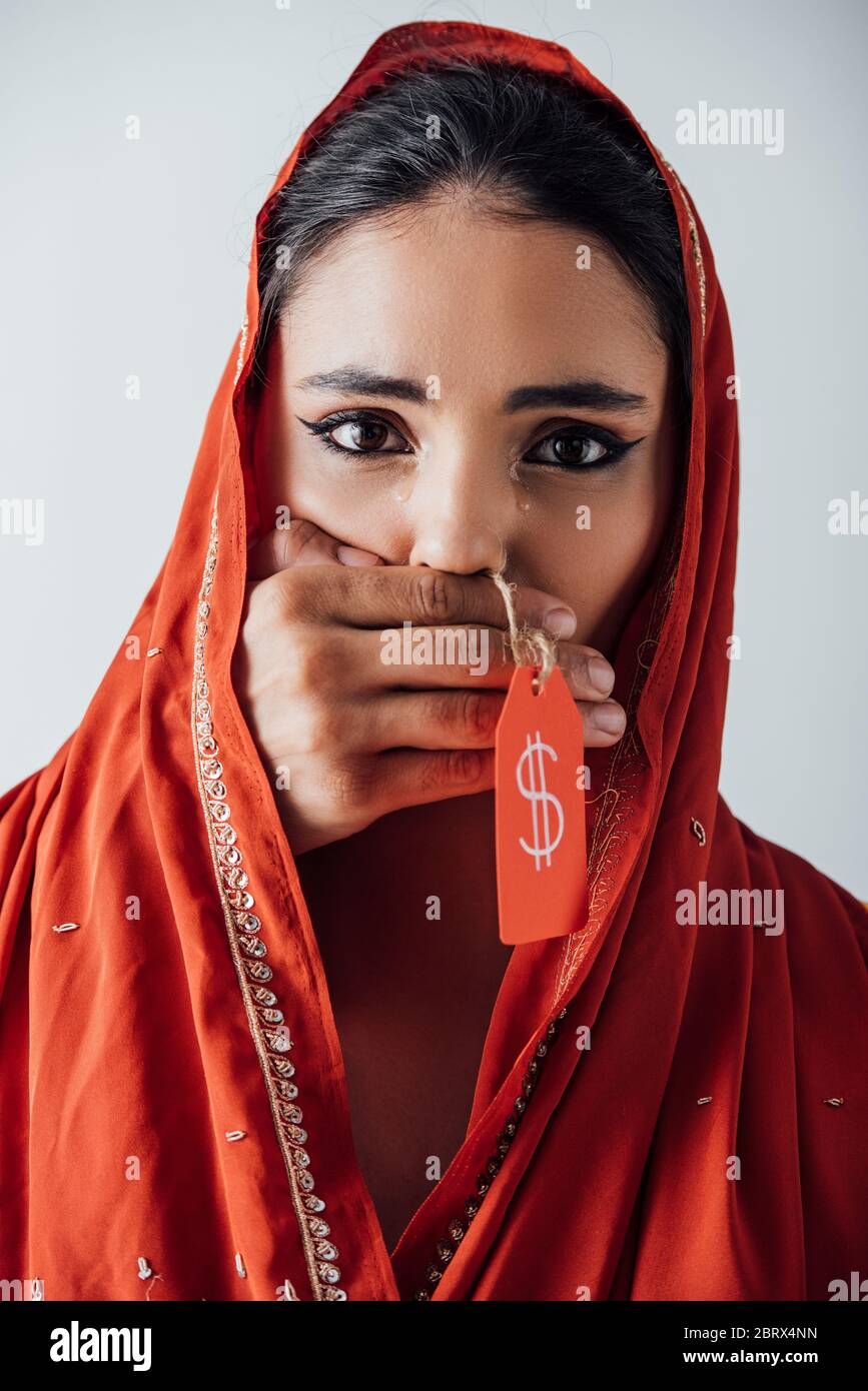 Male hand holding price tag with dollar sign and covering mouth to crying  indian woman in sari isolated on grey Stock Photo - Alamy