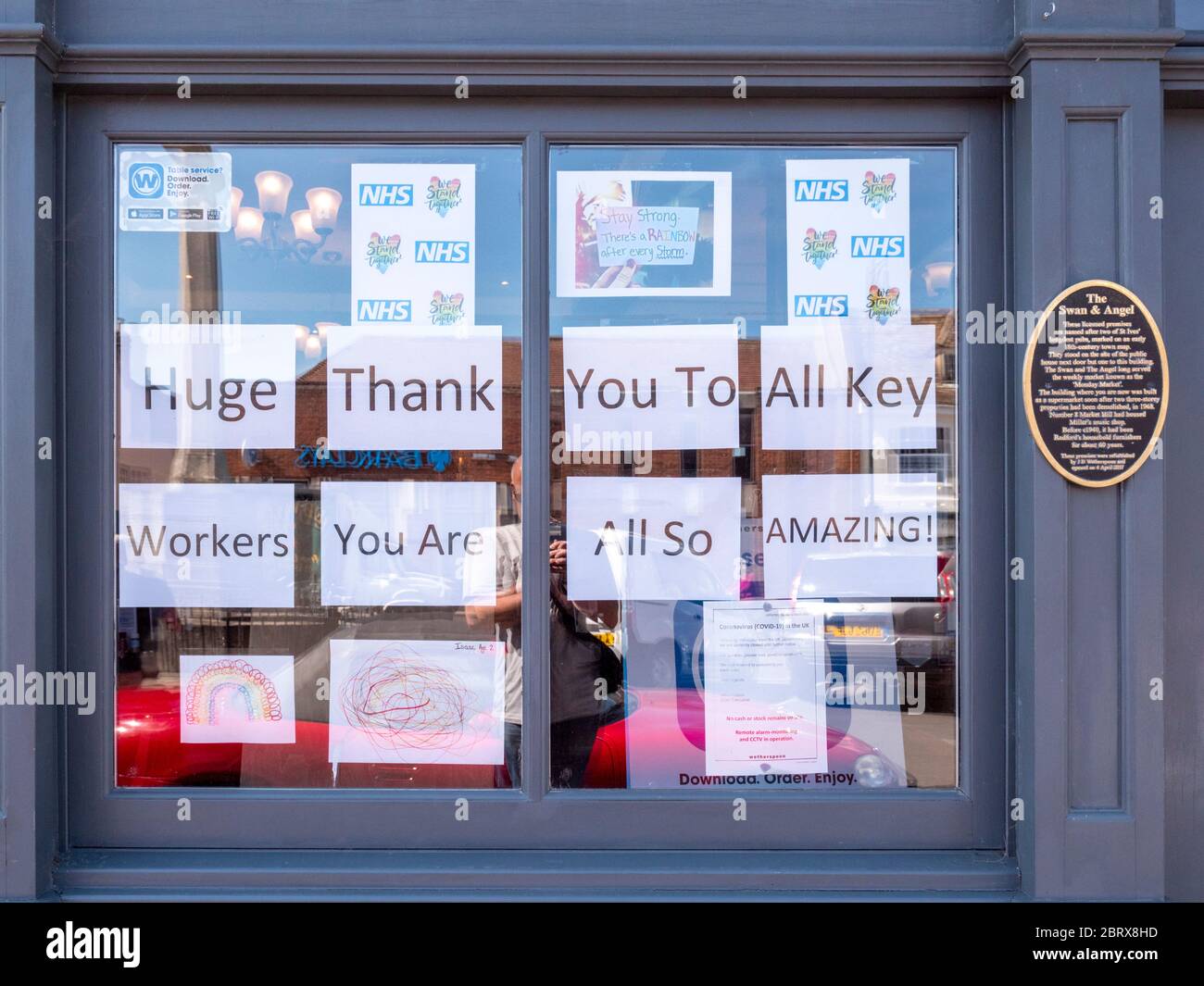 Signs supporting key workers displayed in the window of a Wetherspoons pub the swan and angel in St Ives Cambridgshire UK Stock Photo