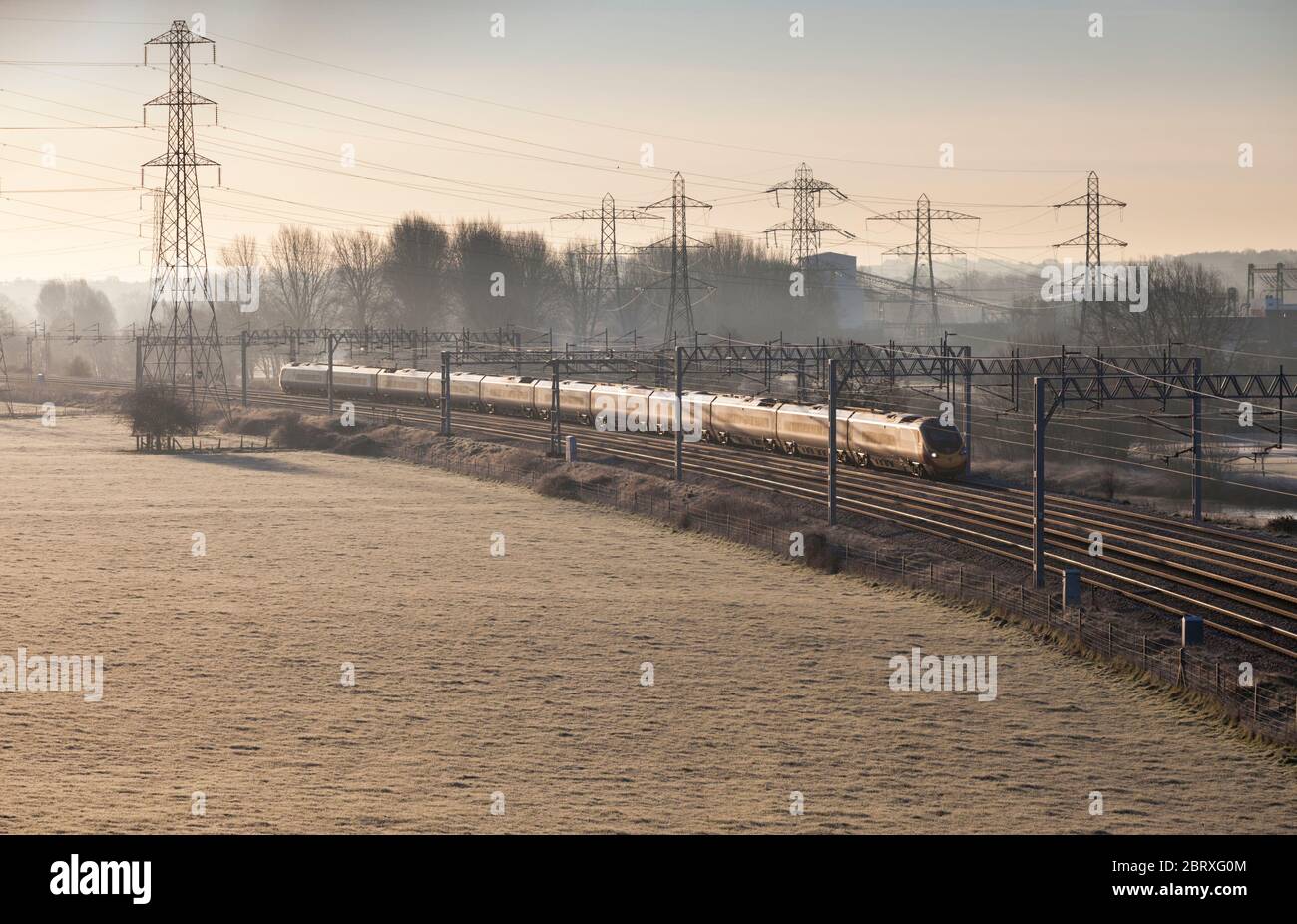 Virgin Trains class 390 Pendolino train under a mass of catenary and ...