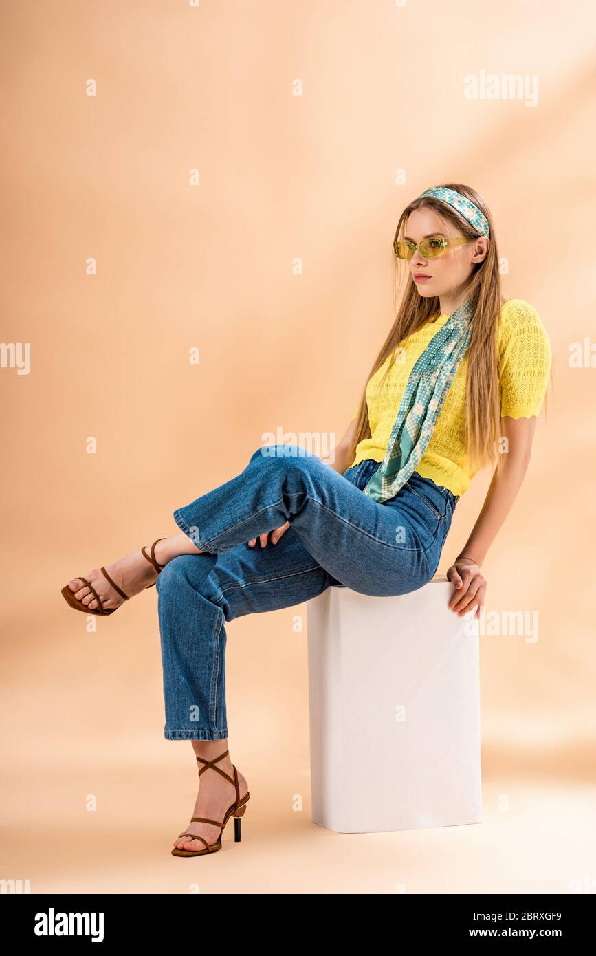 fashionable blonde girl in jeans, yellow t-shirt, sunglasses, heeled ...