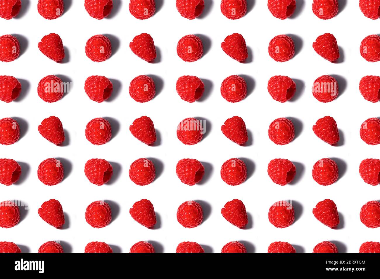 Pattern made of fresh summer raspberry isolated on white. Top view. Stock Photo