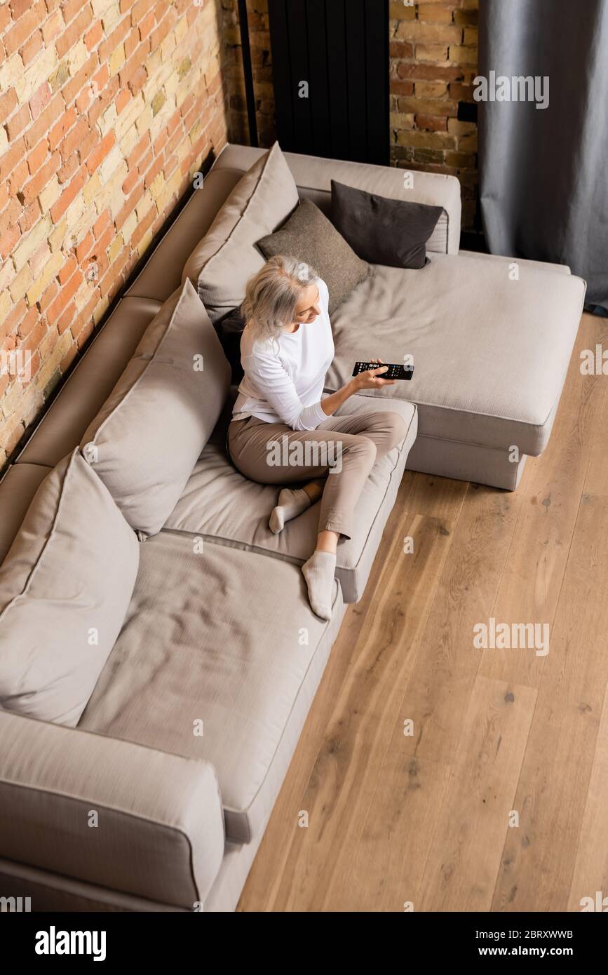 One mature woman in living tv hi-res stock photography and images - Alamy