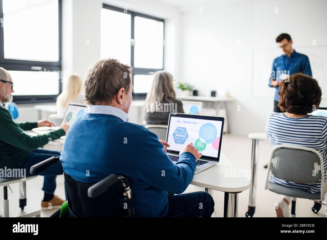 Group of senior people attending computer and technology education class. Stock Photo